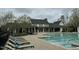 Spacious community pool featuring comfortable lounge chairs and a beautiful backdrop of trees at 237 Abercorn Cir, Chapel Hill, NC 27516