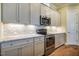 Modern kitchen with stainless steel appliances, granite countertops, and ample cabinet space at 237 Abercorn Cir, Chapel Hill, NC 27516