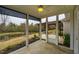 Screened porch with views of the backyard, pergola, and pond at 237 Abercorn Cir, Chapel Hill, NC 27516