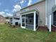 Backyard view showcasing a screened porch and well-maintained lawn at 237 Shingle Oak Rd, Wake Forest, NC 27587