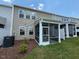 Backyard view featuring a screened porch and neatly landscaped lawn at 237 Shingle Oak Rd, Wake Forest, NC 27587