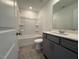 Cozy bathroom features a shower and tub combo, tiled floor, and gray vanity at 237 Shingle Oak Rd, Wake Forest, NC 27587