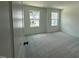 Bright bedroom featuring carpeted floors, white walls, and windows with neighborhood views at 237 Shingle Oak Rd, Wake Forest, NC 27587