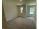 Spacious bedroom with two windows providing natural light and plush carpeting at 237 Shingle Oak Rd, Wake Forest, NC 27587