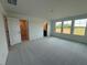 Bright bedroom with three windows, a ceiling light, and neutral carpeting at 237 Shingle Oak Rd, Wake Forest, NC 27587