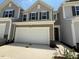 Charming home showcasing a two-car garage with driveway and tasteful exterior design at 237 Shingle Oak Rd, Wake Forest, NC 27587