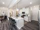 Bright kitchen features a quartz island, pendant lighting, and stainless steel appliances at 237 Shingle Oak Rd, Wake Forest, NC 27587