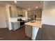 Modern kitchen features a kitchen island, stainless steel appliances and grey cabinets at 237 Shingle Oak Rd, Wake Forest, NC 27587
