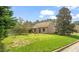 A spacious backyard with chain link fence and mature trees at 2416 Boothbay Ct, Raleigh, NC 27613