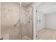 Walk-in shower with neutral tile and glass door at 2416 Boothbay Ct, Raleigh, NC 27613