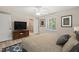 Bedroom featuring a ceiling fan, closet, and window overlooking the green exterior at 2416 Boothbay Ct, Raleigh, NC 27613