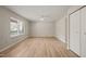 Open bedroom with white walls, hardwood flooring, a window, and a closet at 2416 Boothbay Ct, Raleigh, NC 27613