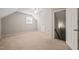 Neutral carpeted bedroom features a ceiling fan and a door to the attic at 2416 Boothbay Ct, Raleigh, NC 27613