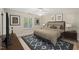 Comfortable bedroom features neutral decor, a ceiling fan, and a window overlooking the green exterior at 2416 Boothbay Ct, Raleigh, NC 27613