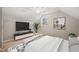 A cozy bedroom with sloped ceilings, plush decor, ceiling fan, and a window overlooking the exterior at 2416 Boothbay Ct, Raleigh, NC 27613