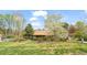 Charming home surrounded by lush greenery, featuring a well-maintained lawn and blooming trees at 2416 Boothbay Ct, Raleigh, NC 27613
