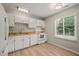 Well-lit kitchen featuring white cabinets and neutral countertops at 2416 Boothbay Ct, Raleigh, NC 27613