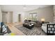 A bright living room showcases a large window, wood flooring, and plush seating perfect for relaxation at 2416 Boothbay Ct, Raleigh, NC 27613