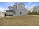 Spacious backyard with gray siding, dark roofing, and a well-maintained lawn reaching a dark metal fence line at 248 Shingle Oak Rd, Wake Forest, NC 27587