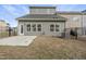 Fenced backyard with gray siding, a small patio, and sparse grass leading up to the metal perimeter fencing at 248 Shingle Oak Rd, Wake Forest, NC 27587