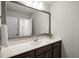 Bathroom vanity with a dark wood cabinet, white countertop, and a large mirror at 248 Shingle Oak Rd, Wake Forest, NC 27587