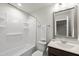 Well-lit bathroom with shower-tub, white fixtures, and a vanity featuring a neutral-toned countertop and a framed mirror at 248 Shingle Oak Rd, Wake Forest, NC 27587