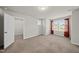 A carpeted bedroom with a window and an open closet, offering comfort and natural light at 248 Shingle Oak Rd, Wake Forest, NC 27587