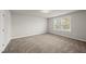A carpeted bedroom with a window, providing a bright and relaxing space at 248 Shingle Oak Rd, Wake Forest, NC 27587