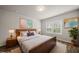 Staged bedroom with stylish decor, a large window, and ample natural light for a comfortable retreat at 248 Shingle Oak Rd, Wake Forest, NC 27587