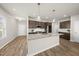 Modern kitchen features granite countertops, stainless steel appliances, an island, and ample storage space at 248 Shingle Oak Rd, Wake Forest, NC 27587