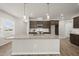 Spacious kitchen island featuring granite countertops, a sink, and ample storage space at 248 Shingle Oak Rd, Wake Forest, NC 27587