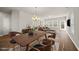 Open-concept living and dining area with hardwood floors, elegant lighting, and comfortable furnishings at 248 Shingle Oak Rd, Wake Forest, NC 27587