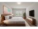 Stylishly furnished bedroom with wood floors, a large window, and a calming color palette at 248 Shingle Oak Rd, Wake Forest, NC 27587