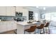 Bright kitchen with white cabinets, stainless steel appliances, island seating, and a stylish backsplash at 249 Spilona Way # 64, Four Oaks, NC 27524