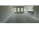 Spacious living room filled with natural light from large windows overlooking the landscaped backyard at 249 Spilona Way # 64, Four Oaks, NC 27524