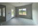 Bright living room showcasing a glass door for outdoor access and windows with views of nature at 249 Spilona Way # 64, Four Oaks, NC 27524