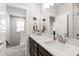 Modern bathroom with white quartz countertops, dark wood cabinets, and bright lighting at 249 Wendover Pkwy, Pittsboro, NC 27312