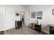Spacious bedroom with gray carpet, with a wine cooler and sports themed artwork at 249 Wendover Pkwy, Pittsboro, NC 27312