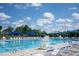 Community pool with many lounge chairs and blue canopies offers a relaxing escape on a sunny day at 249 Wendover Pkwy, Pittsboro, NC 27312