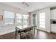 Dining area with views of the outdoors with lots of natural light and modern chandelier at 249 Wendover Pkwy, Pittsboro, NC 27312