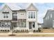 Charming two-story townhome with stone accents and a white picket fence at 249 Wendover Pkwy, Pittsboro, NC 27312