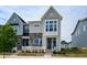 Charming new construction townhome with mixed stone and siding, manicured lawn, and bright curb appeal at 249 Wendover Pkwy, Pittsboro, NC 27312