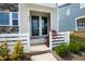 Inviting front door entrance with a decorative tree and neatly trimmed shrubs and a white fence at 249 Wendover Pkwy, Pittsboro, NC 27312