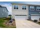 Two-car garage door and driveway and manicured yard on a sunny day at 249 Wendover Pkwy, Pittsboro, NC 27312