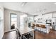 Bright, open kitchen with stainless steel appliances and large island adjacent to a dining table at 249 Wendover Pkwy, Pittsboro, NC 27312