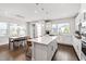 Bright, open kitchen area with large island, stainless appliances, and a dining table at 249 Wendover Pkwy, Pittsboro, NC 27312
