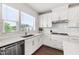 Modern kitchen boasting white cabinets, quartz countertops, stainless steel appliances, and ample natural light at 249 Wendover Pkwy, Pittsboro, NC 27312