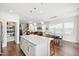 Open-concept kitchen featuring a center island with white countertops and stainless steel accents at 249 Wendover Pkwy, Pittsboro, NC 27312