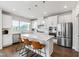 Kitchen featuring stainless steel appliances, white cabinets, quartz countertops, and eat-in island at 249 Wendover Pkwy, Pittsboro, NC 27312