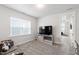 Comfortable living room with neutral walls, a TV, and lots of natural light at 249 Wendover Pkwy, Pittsboro, NC 27312